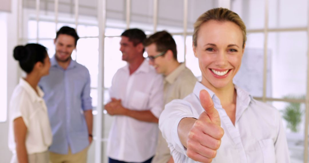 Smiling Businesswoman Giving Thumbs Up in Office - Free Images, Stock Photos and Pictures on Pikwizard.com