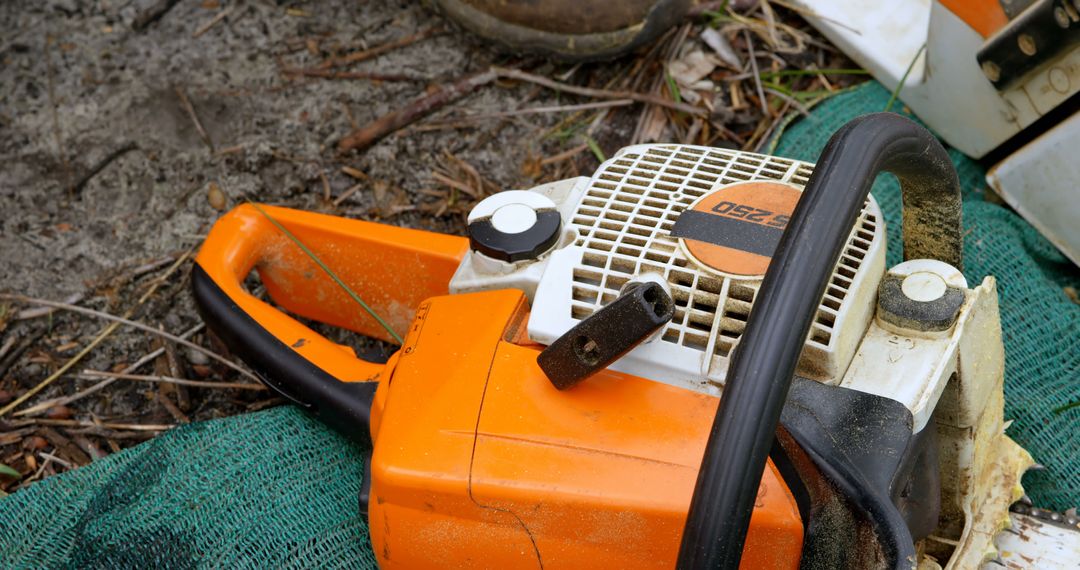 Close-up of Chainsaw on Ground in Outdoor Setting - Free Images, Stock Photos and Pictures on Pikwizard.com