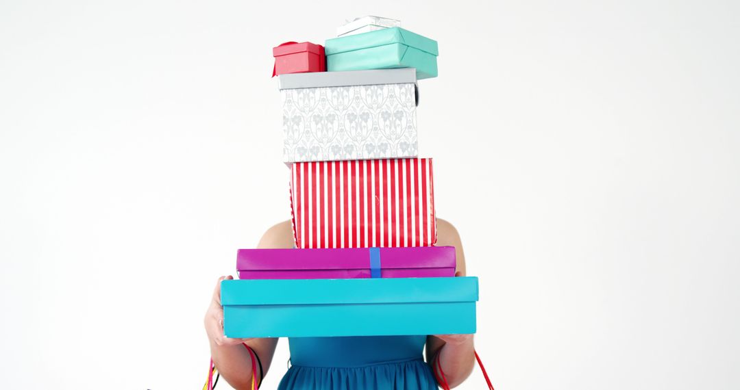 Person Holding Stack of Colorful Gift Boxes on White Background - Free Images, Stock Photos and Pictures on Pikwizard.com