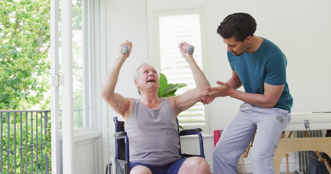 Elderly man in wheelchair lifting dumbbells with assistance from male physiotherapist - Free Images, Stock Photos and Pictures on Pikwizard.com