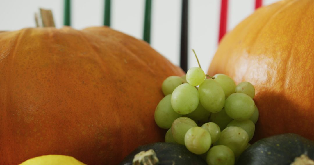 Fresh Autumn Harvest with Green Grapes and Pumpkins - Free Images, Stock Photos and Pictures on Pikwizard.com