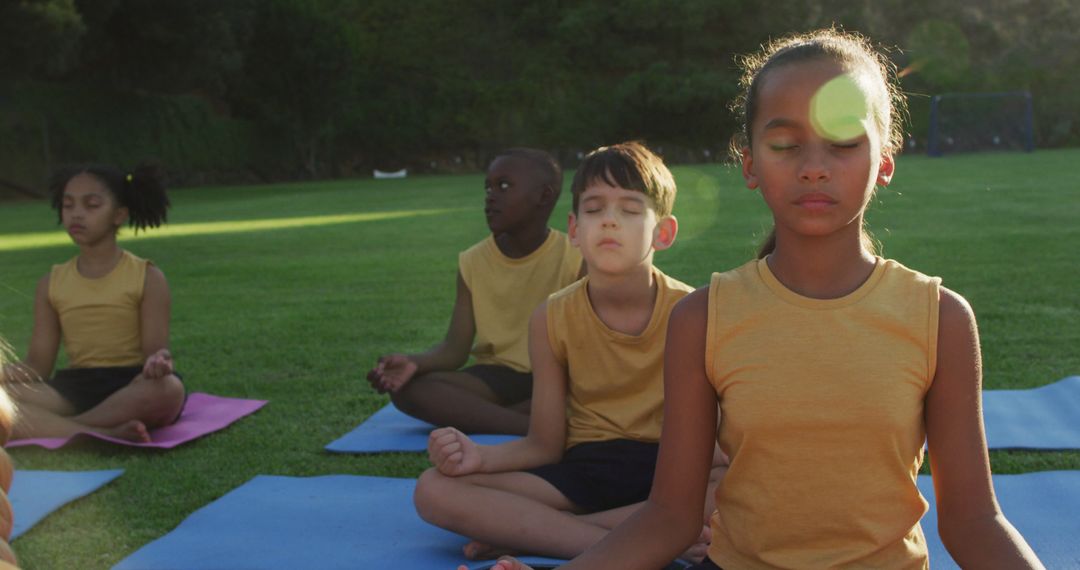 Children Meditating Outdoors in Sunshine on Yoga Mats - Free Images, Stock Photos and Pictures on Pikwizard.com