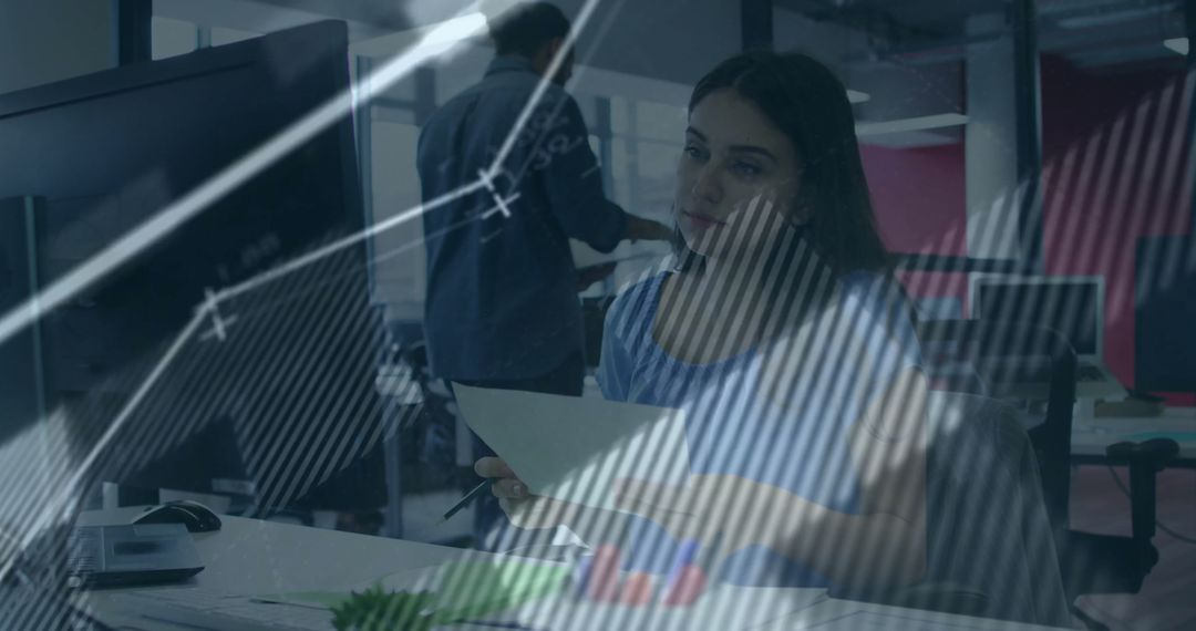 Businesswoman Analyzing Financial Data at Office Desk