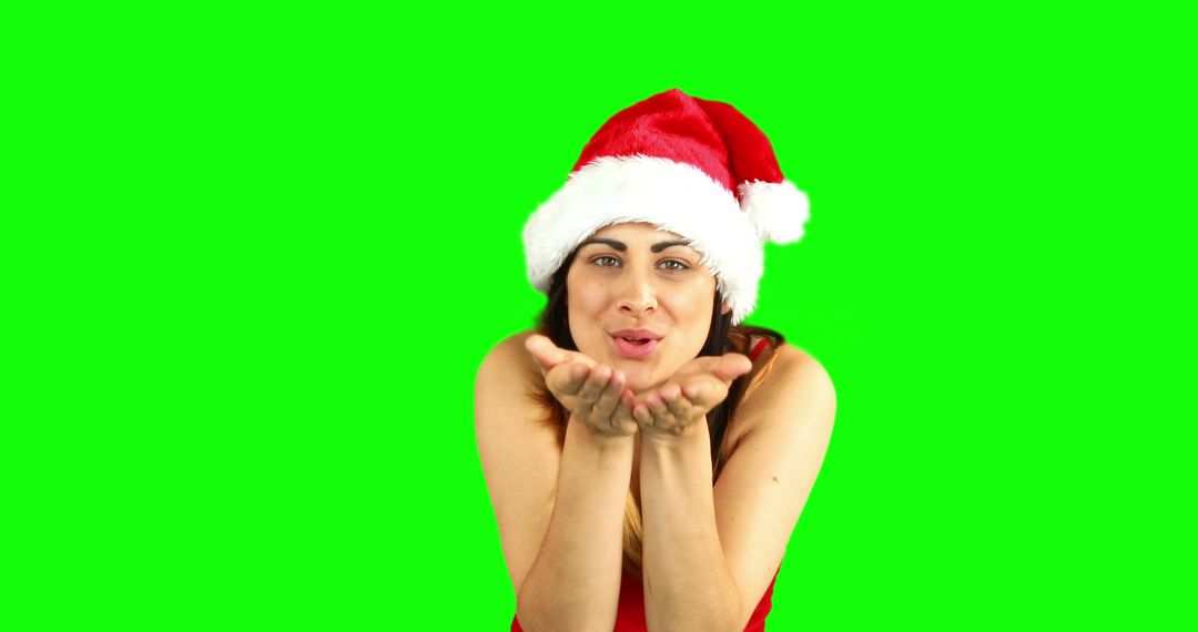 Woman Wearing Santa Hat Blowing Kiss on Green Screen Background - Free Images, Stock Photos and Pictures on Pikwizard.com