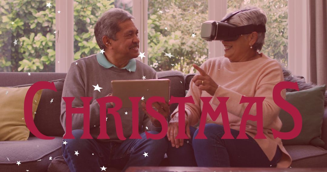 Senior Couple Enjoying Virtual Reality And Tablet At Home During Christmas