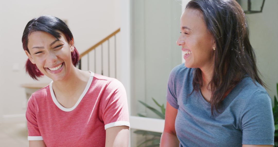 Two Women Laughing and Conversing in Casual Wear - Free Images, Stock Photos and Pictures on Pikwizard.com