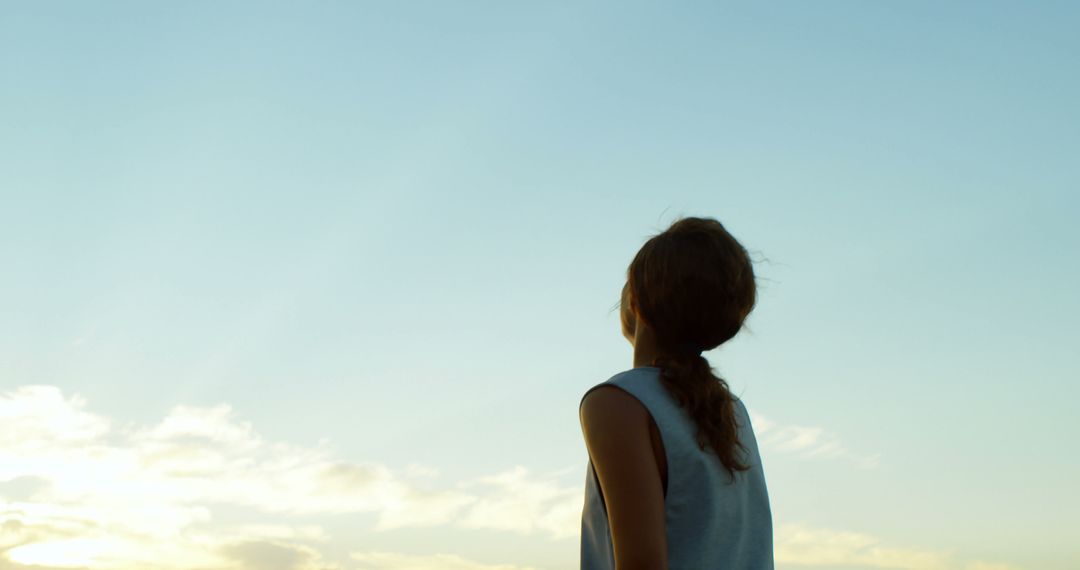 Child Gazing at Clear Sky During Sunset - Free Images, Stock Photos and Pictures on Pikwizard.com