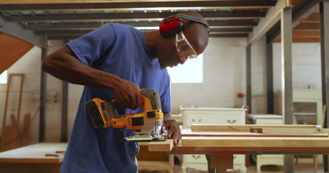 Skilled Craftsman Using Jigsaw for Woodworking in Atelier