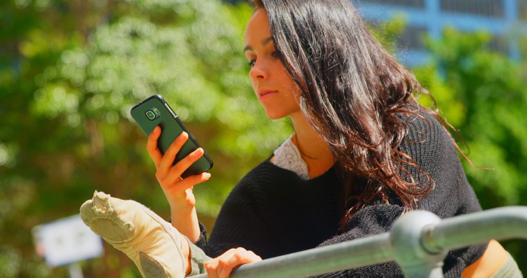 Young Woman Checking Smartphone Outdoors - Free Images, Stock Photos and Pictures on Pikwizard.com