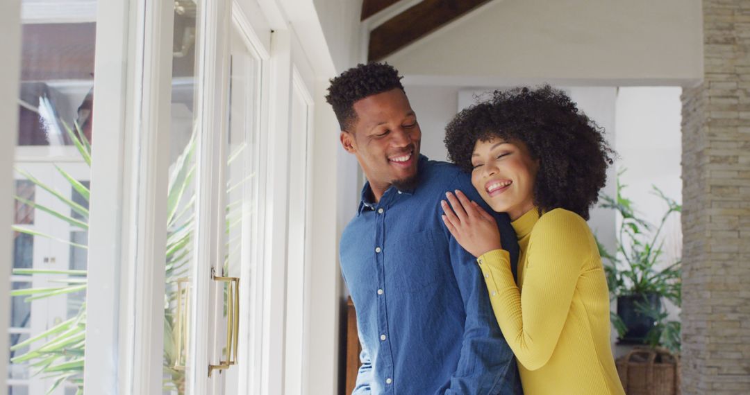 Happy african american couple embracing together at home - Free Images, Stock Photos and Pictures on Pikwizard.com