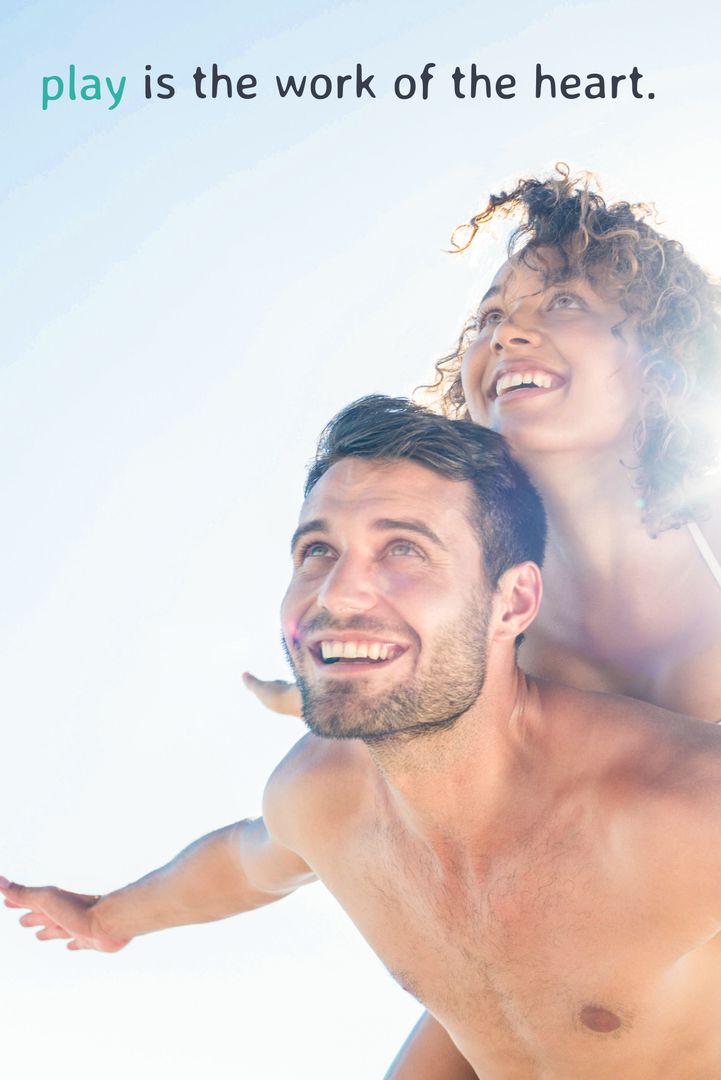 Carefree Joyful Couple Piggyback Ride at Beach