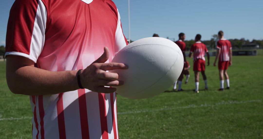 Rugby Player Holding Ball During Team Practice on Field - Free Images, Stock Photos and Pictures on Pikwizard.com