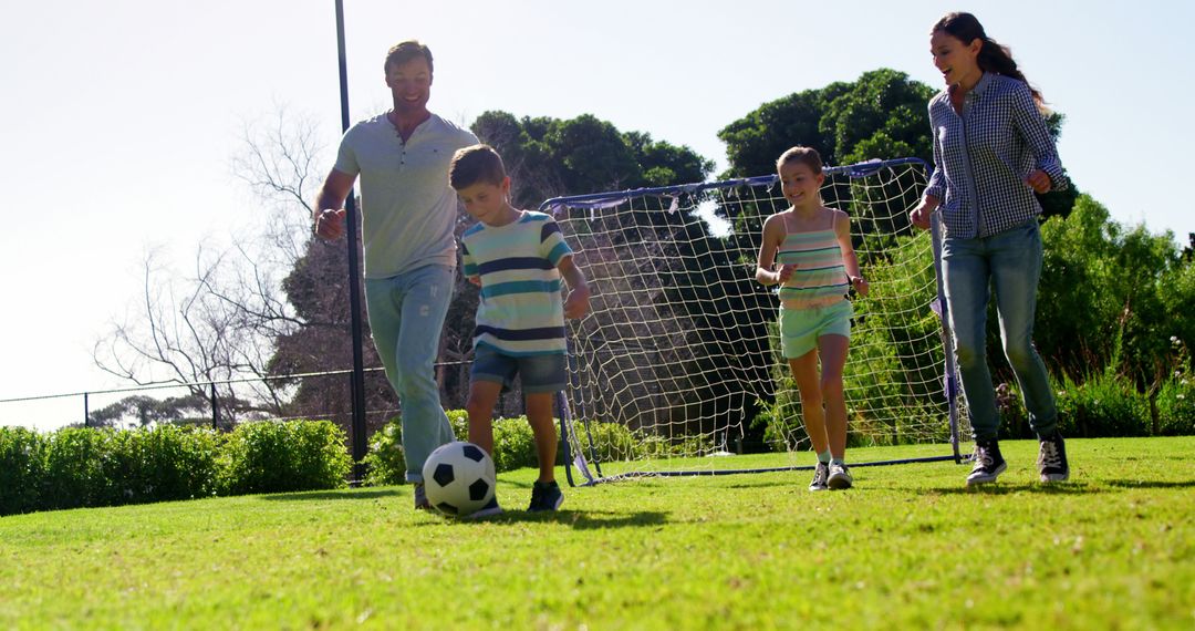 Family Enjoying Outdoor Soccer Game in Park - Free Images, Stock Photos and Pictures on Pikwizard.com