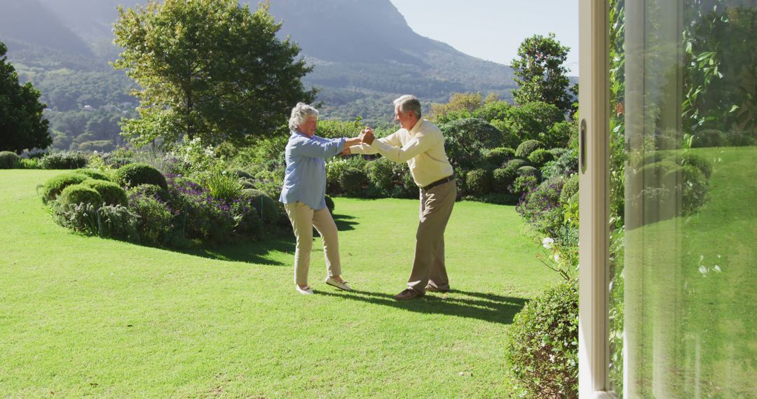 Senior Couple Dancing Joyfully in Garden on Sunny Day - Free Images, Stock Photos and Pictures on Pikwizard.com