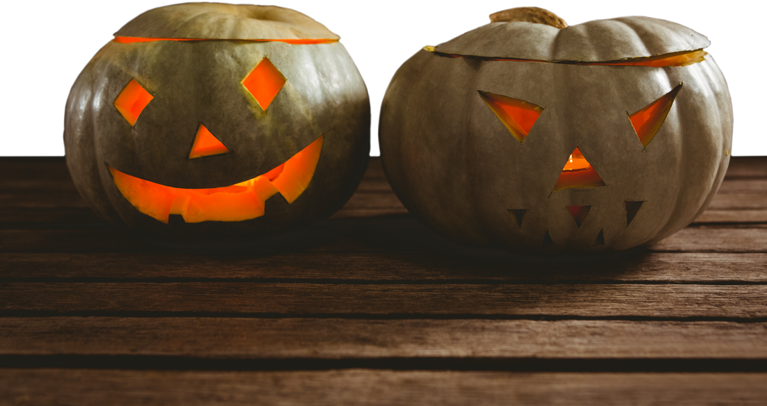 Two Transparent Lit Jack O Lanterns Sitting on Wooden Table - Download Free Stock Images Pikwizard.com