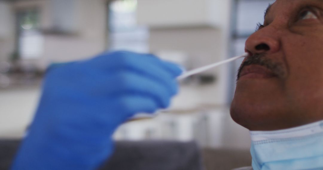 Healthcare Worker Conducting COVID-19 Nasal Swab Test on Patient - Free Images, Stock Photos and Pictures on Pikwizard.com