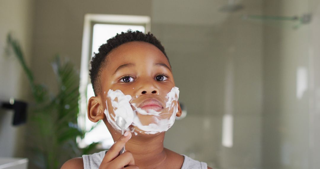 Image of african american boy shaving in bathroom - Free Images, Stock Photos and Pictures on Pikwizard.com