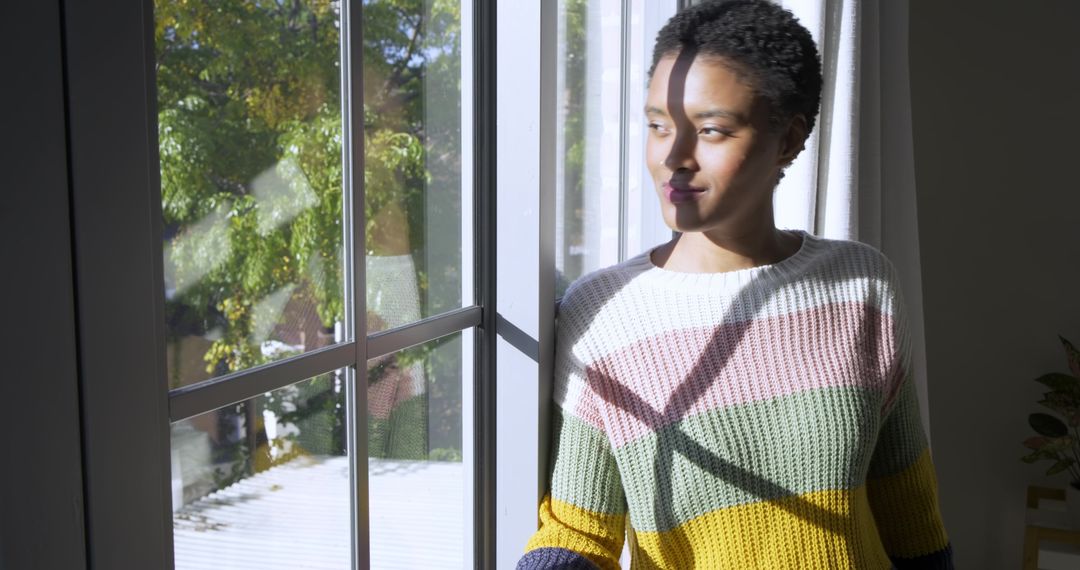 Woman Relaxing by Sunlit Window in Cozy Home