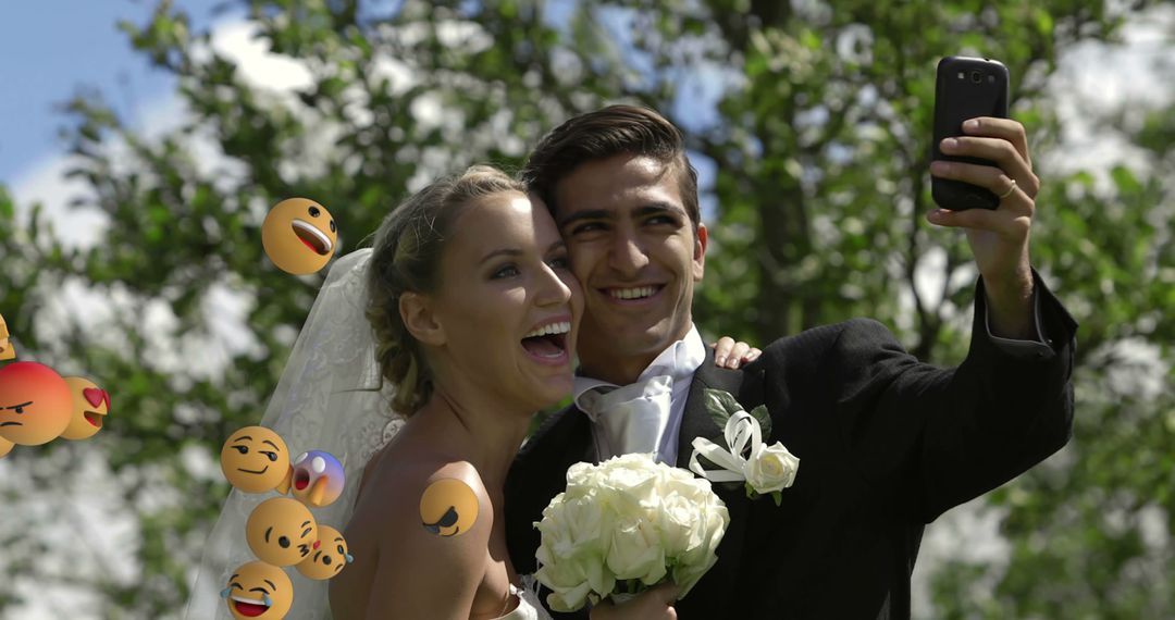 Bride and Groom Taking Wedding Selfie with Emojis Floating Around - Free Images, Stock Photos and Pictures on Pikwizard.com