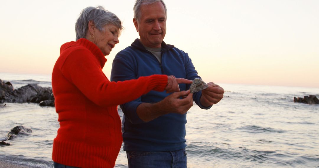 Senior Couple Enjoying Seaside Exploration at Sunset - Free Images, Stock Photos and Pictures on Pikwizard.com