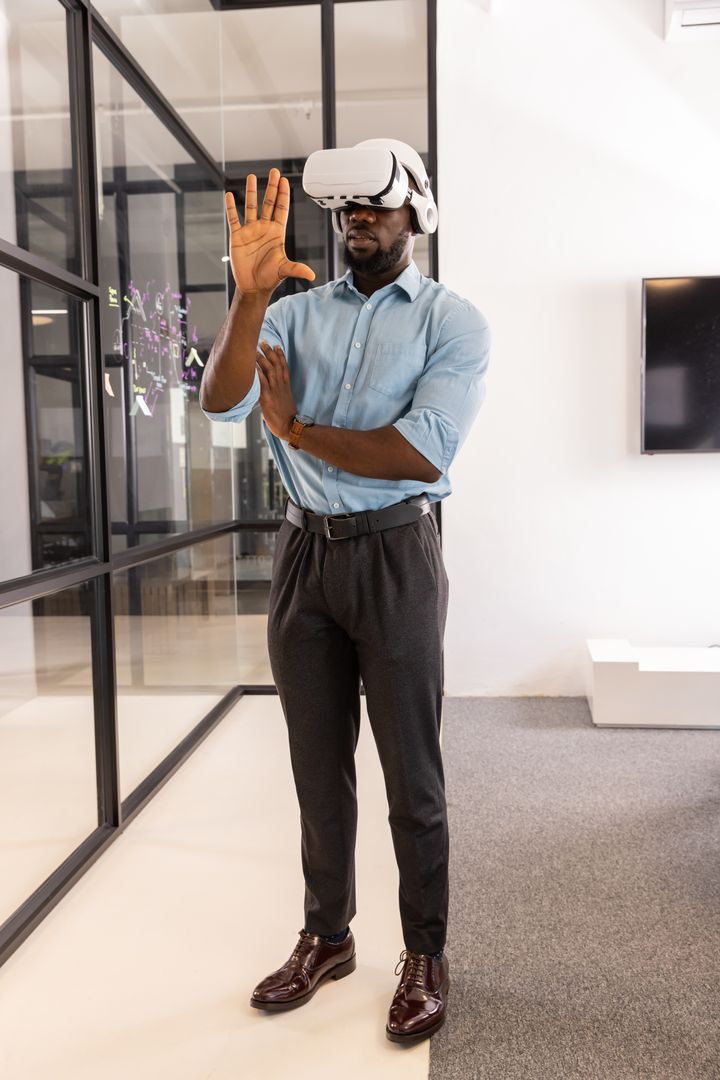 Professional Man in Office Using VR Headset for Interactive Display