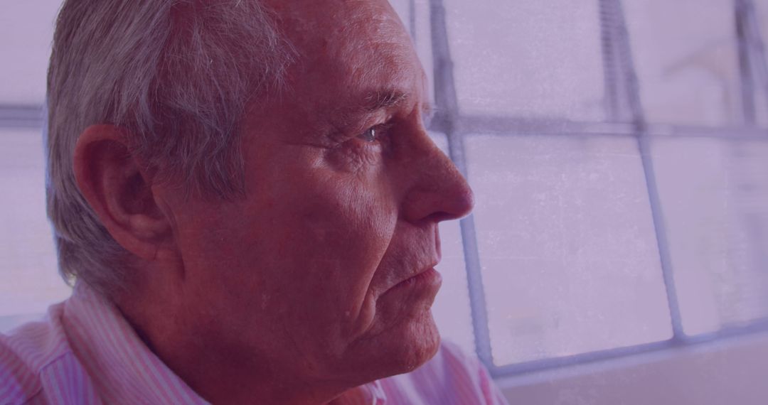 Pensive Elderly Man Gazing Out of Window