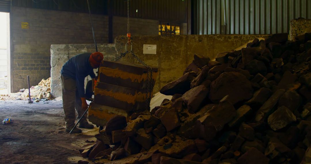 Worker Handling Large Stone Blocks in Industrial Warehouse - Free Images, Stock Photos and Pictures on Pikwizard.com