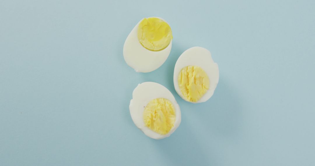 Three Halved Boiled Eggs on Light Blue Background - Free Images, Stock Photos and Pictures on Pikwizard.com