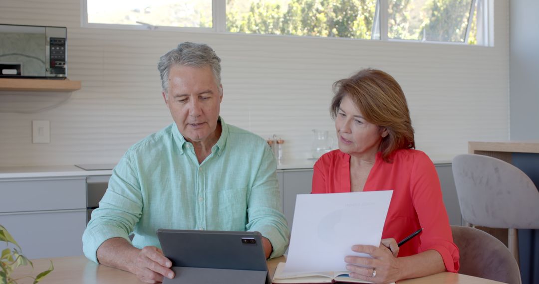 Senior Couple Reviewing Finances Together Using Tablet