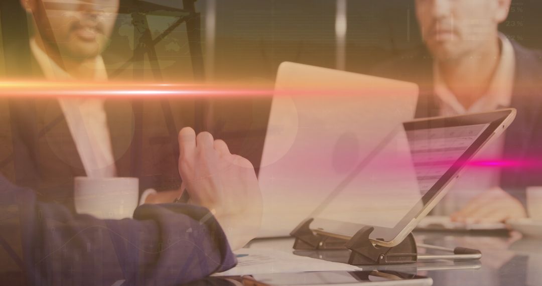 Business Professionals Analyzing Data on Laptop Screens in Office Setting