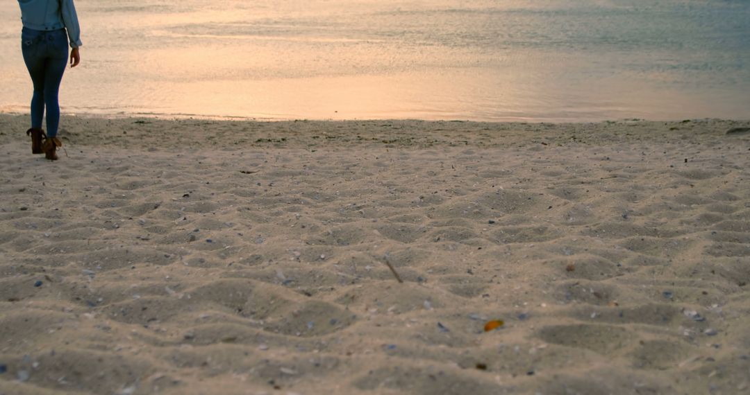 Person Walking on Sandy Beach at Sunset - Free Images, Stock Photos and Pictures on Pikwizard.com