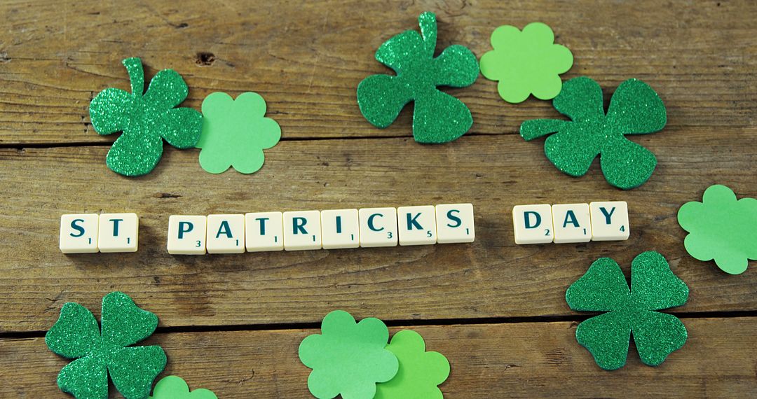 St. Patrick's Day Scrabble Tiles and Shamrocks on Wooden Background - Free Images, Stock Photos and Pictures on Pikwizard.com