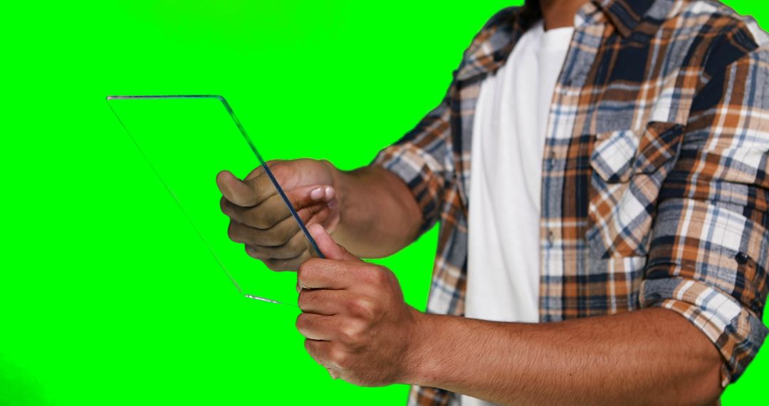 Man Holding Transparent Tablet Mockup with Green Screen Background - Free Images, Stock Photos and Pictures on Pikwizard.com