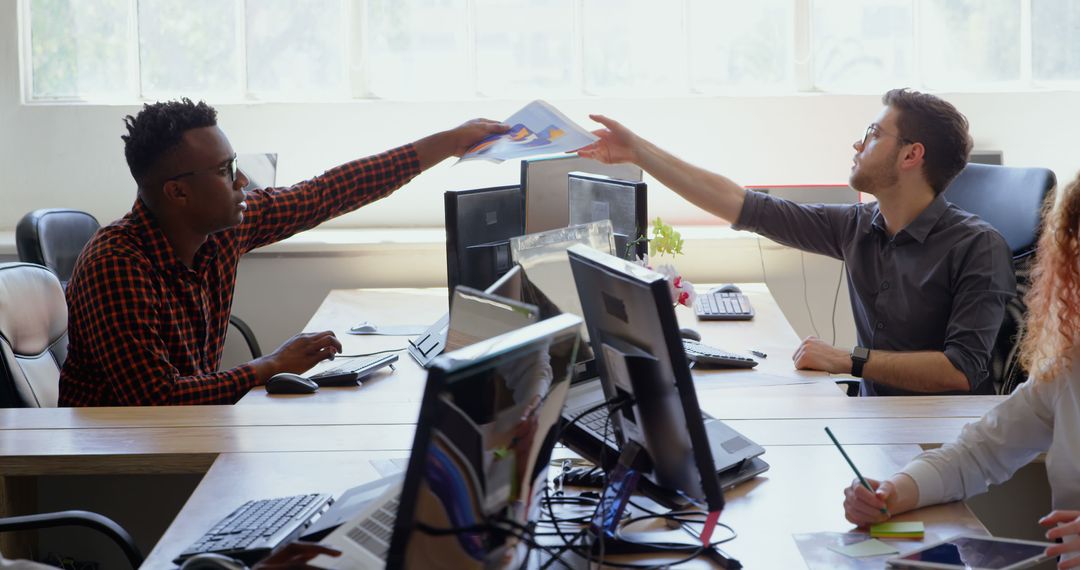Diverse Colleagues Sharing Documents in Collaborative Office Workspace