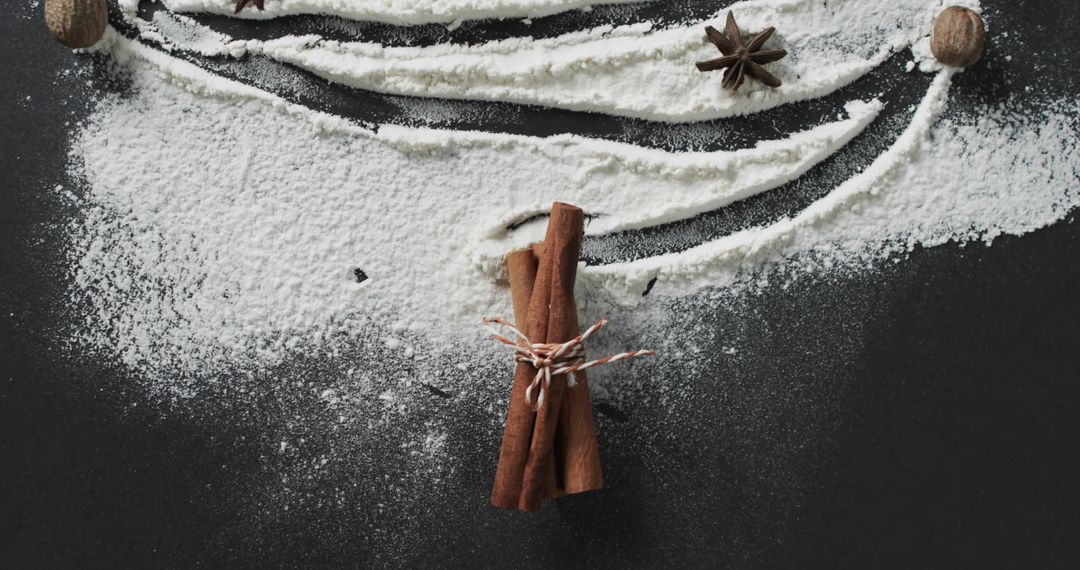 Cinnamon Sticks with Flour and Star Anise on Dark Surface
