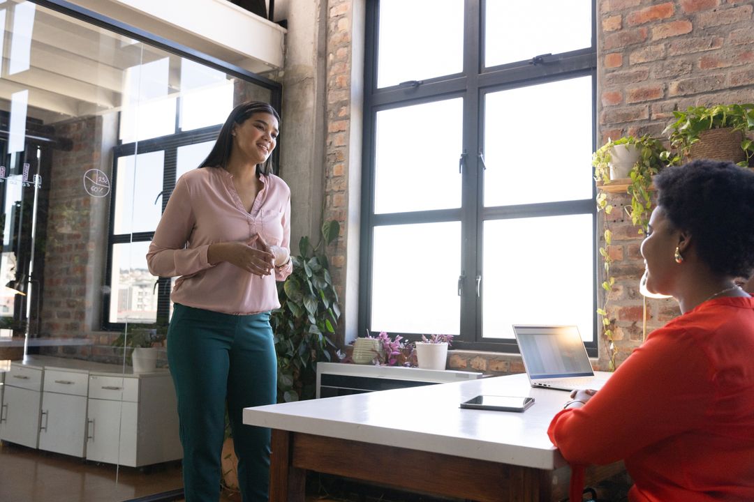 Diverse Female Colleagues Collaborating in Creative Office Environment