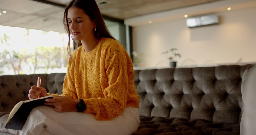 Woman Writing in Notebook in Cozy Minimalist Space