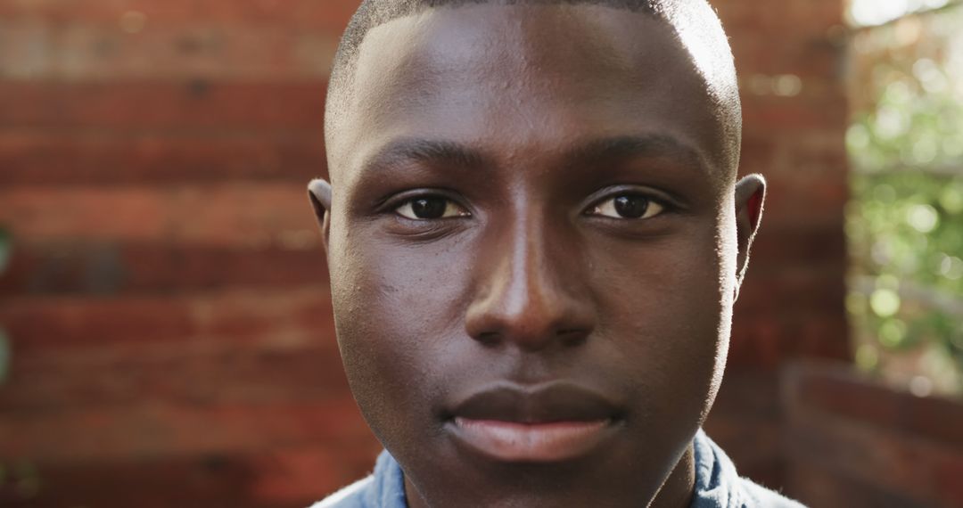 Portrait of Young African American Man with Serious Expression Outdoors - Free Images, Stock Photos and Pictures on Pikwizard.com