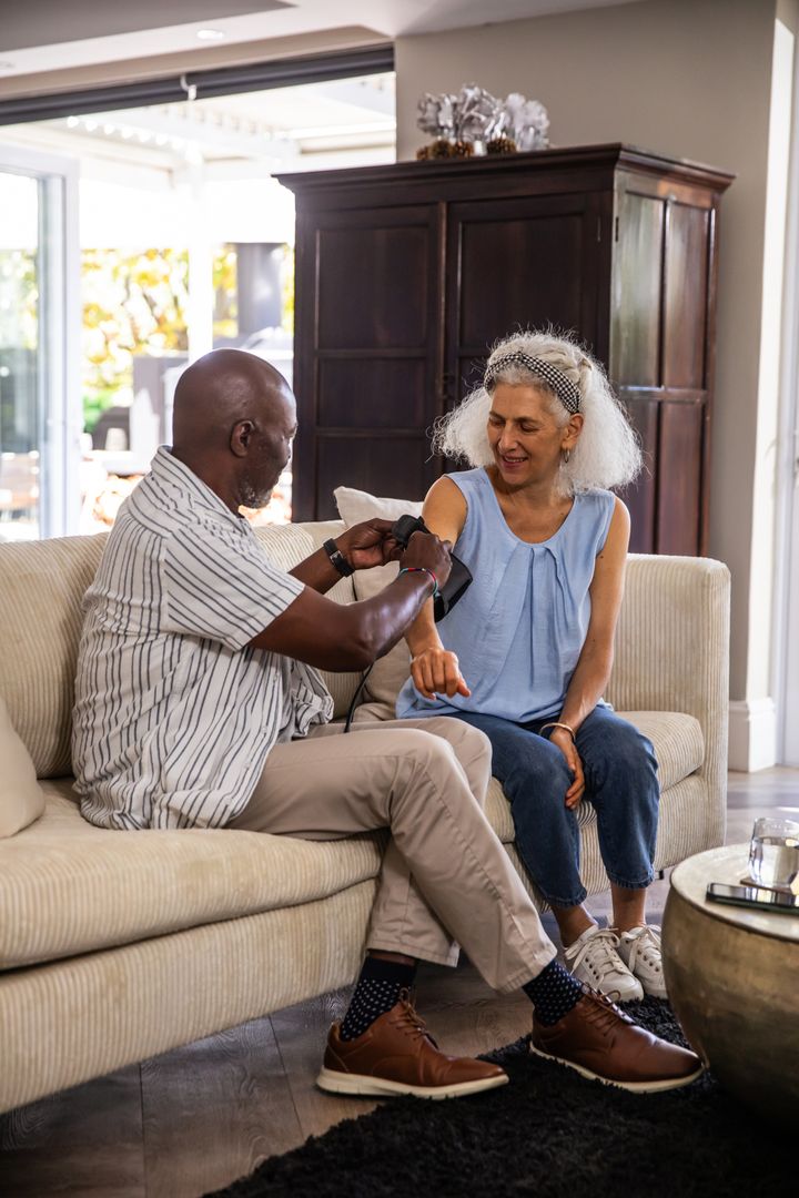 Senior Couple Enjoying Routine Health Check at Home Together
