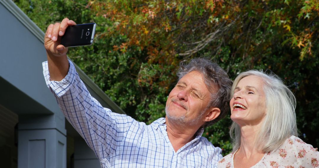 Senior Couple Taking Selfie Outdoors on a Sunny Day - Free Images, Stock Photos and Pictures on Pikwizard.com