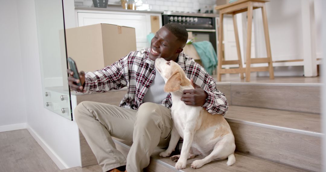 Young Man Taking Selfie with Dog in New Home - Free Images, Stock Photos and Pictures on Pikwizard.com