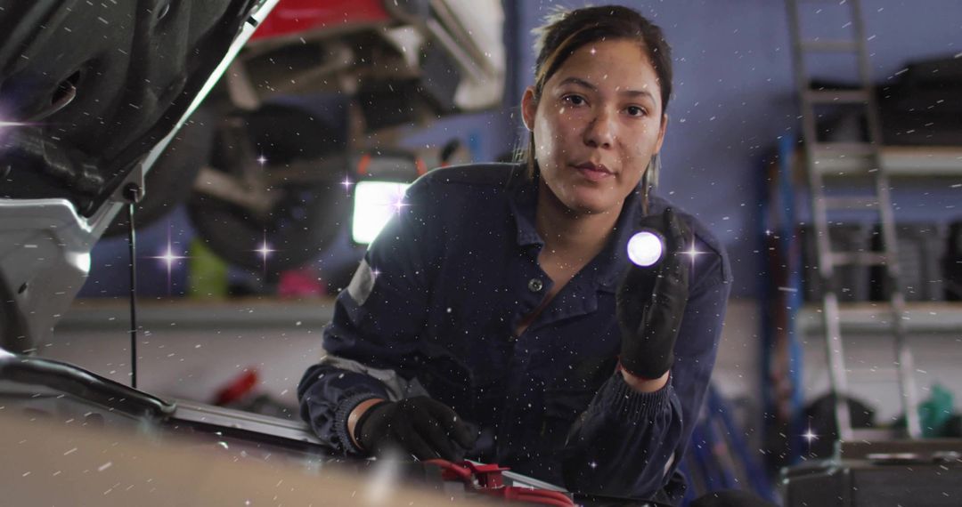Female Mechanic Conducting Engine Check with Flashlight in Workshop