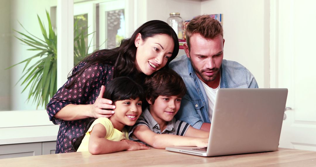 Happy Family Using Laptop in Modern Kitchen - Free Images, Stock Photos and Pictures on Pikwizard.com