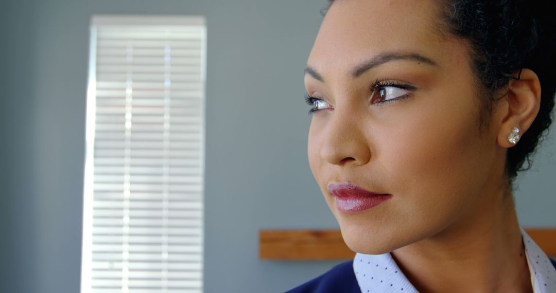 Confident Woman in Office Looking Through Window - Free Images, Stock Photos and Pictures on Pikwizard.com