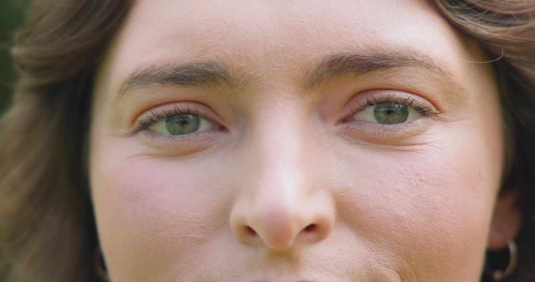 Freckled Woman in Nature with Silver Hoop Earrings