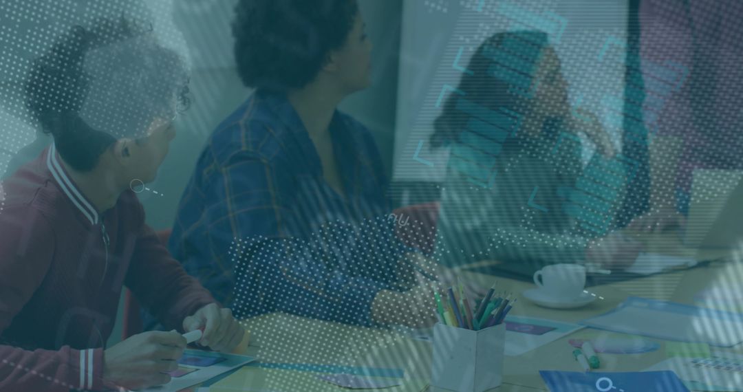 Collaborating team brainstorming around meeting table with laptop and whiteboard