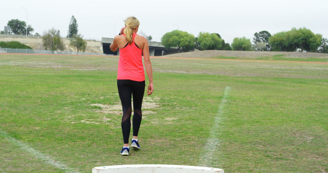 Woman Running on Grass Field in Pink Tank Top - Free Images, Stock Photos and Pictures on Pikwizard.com