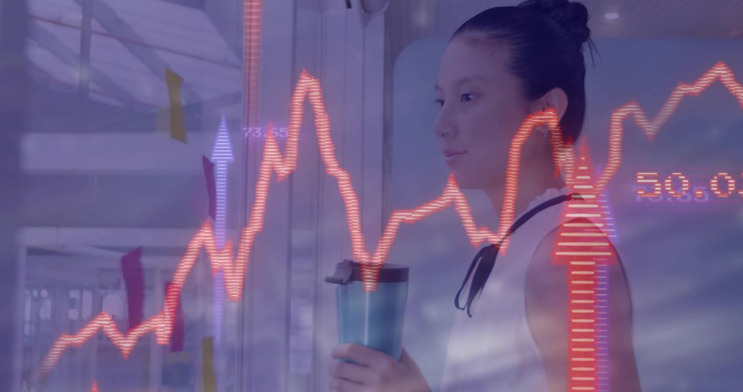 Asian Woman Analyzing Digital Financial Data in Office Setting