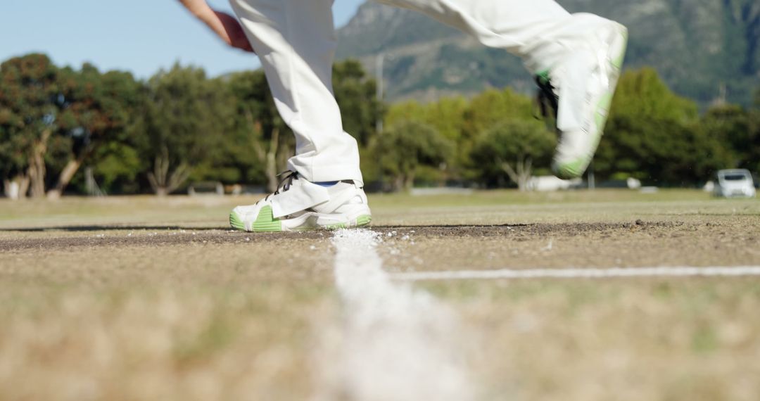 Cricketer Running on Pitch Wearing White Pants and Green-Accented Shoes - Free Images, Stock Photos and Pictures on Pikwizard.com