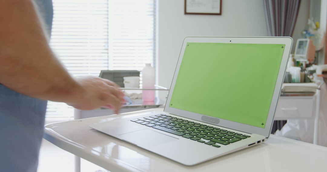 Medical Professional Using Laptop with Green Screen in Clinic - Free Images, Stock Photos and Pictures on Pikwizard.com